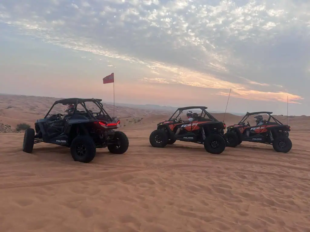 3 dune buggies in desert